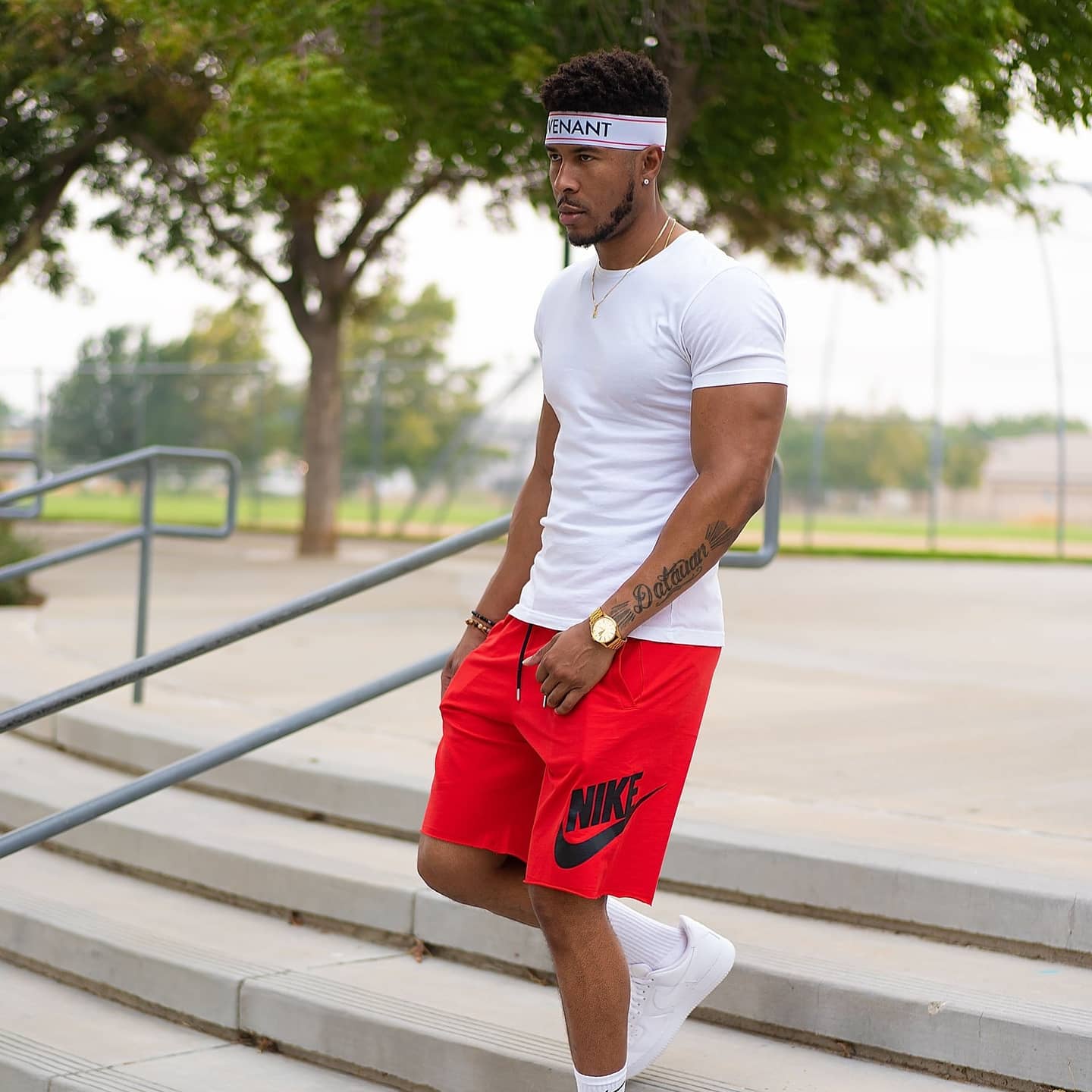 A gaming commentator at a desk with headphones, speaking into a microphone with a monitor in view