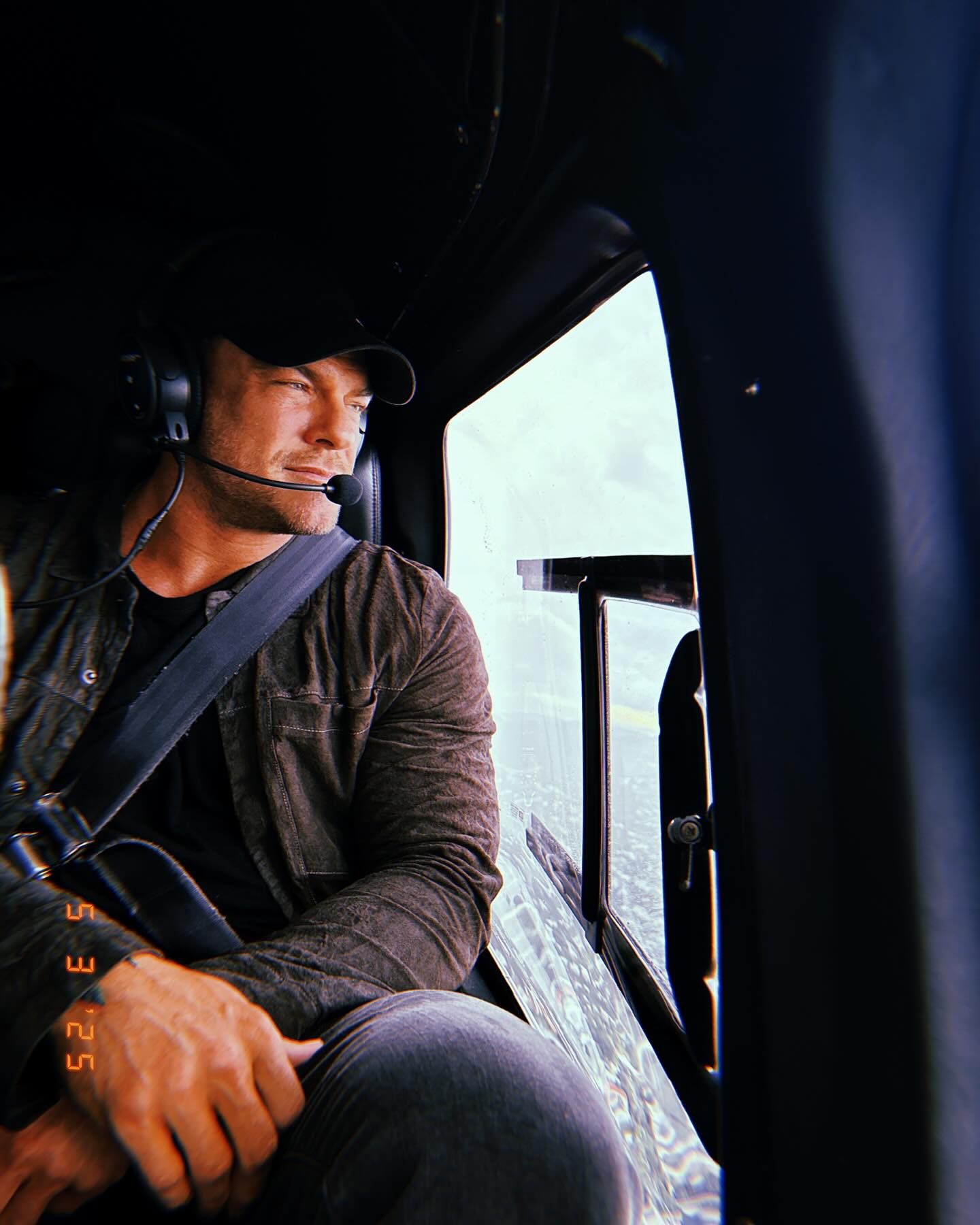 Alan Ritchson standing in a doorway, broad-shouldered and towering, conveying the imposing presence of Jack Reacher