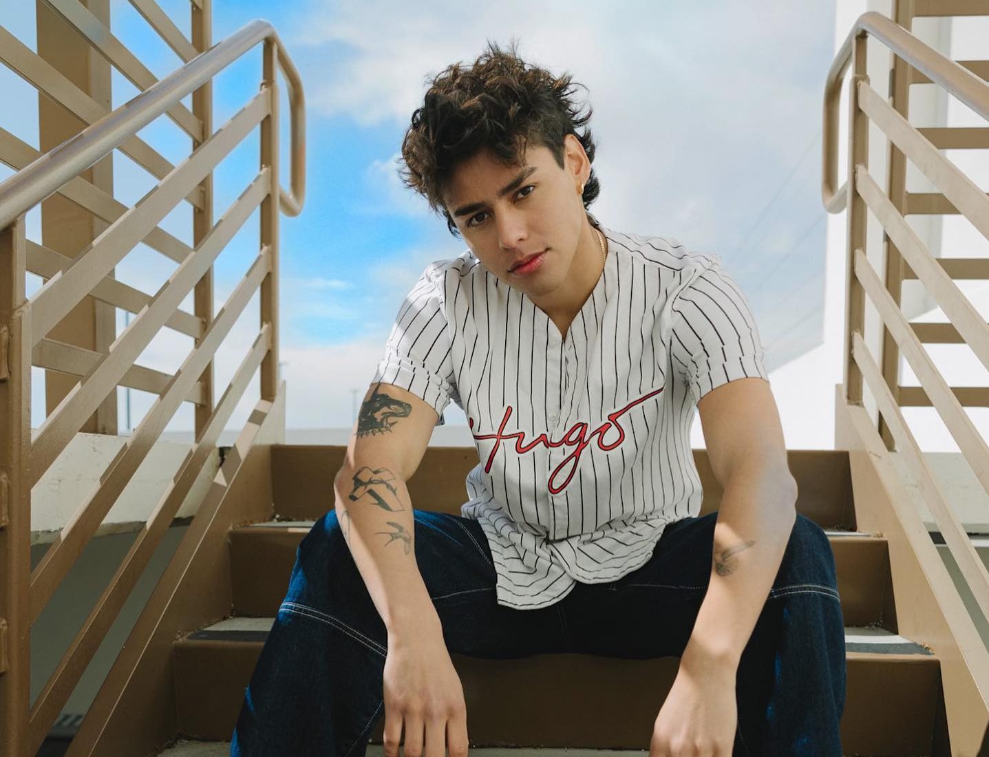 Andrew Davila in a relaxed pose, casual outfit, natural lighting, conveying an approachable and authentic style.