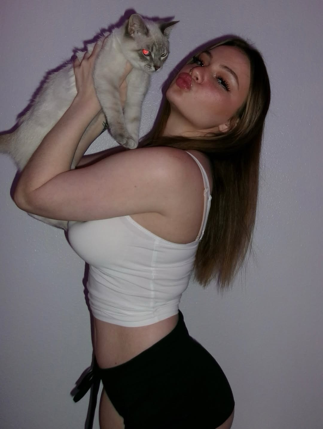 Ava Reyes wearing bold, high-contrast makeup while filming a short-form video and holding an iced coffee prop