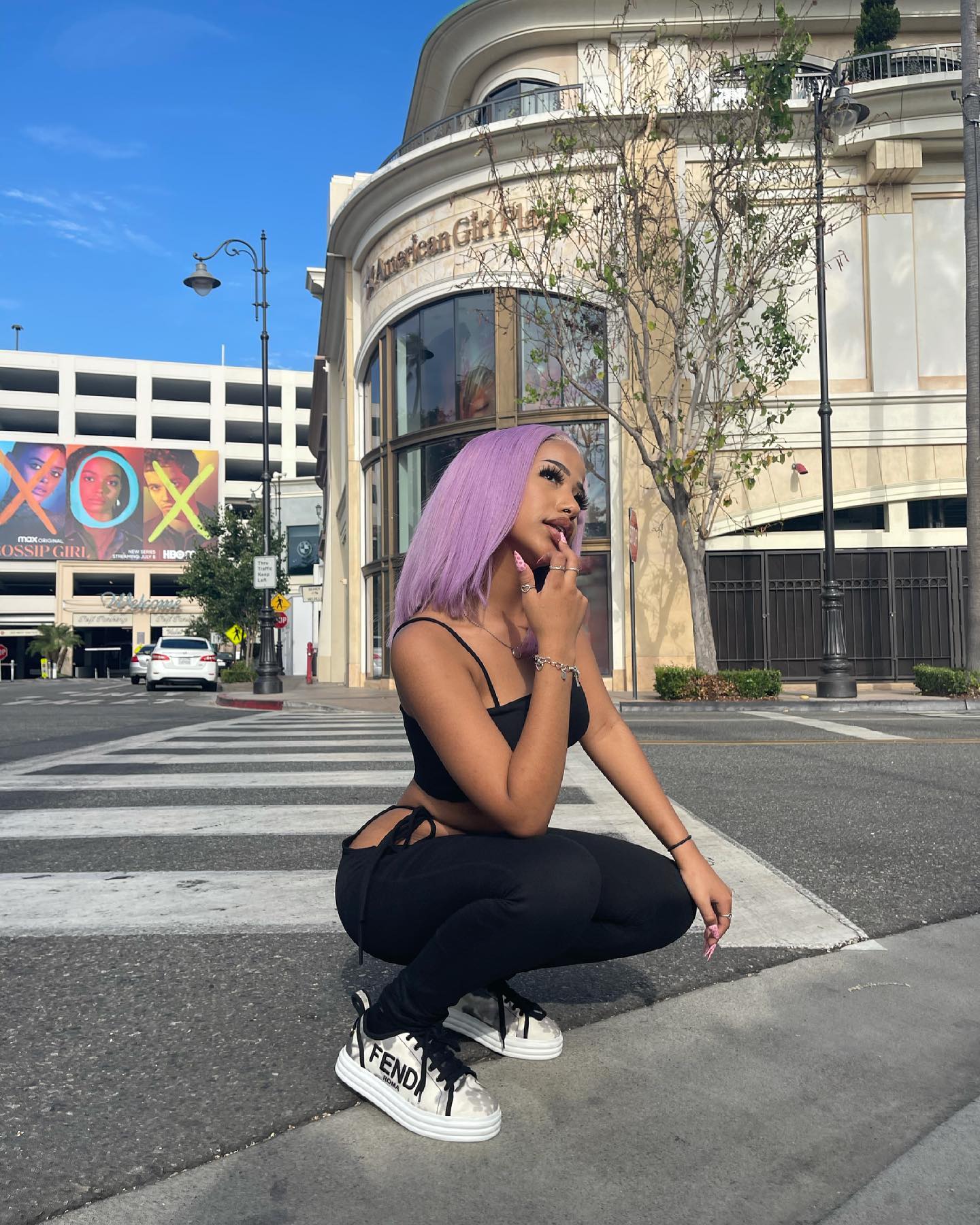 Aya Tanjali smiling and performing a short dance move in a casual home setting, emphasizing her expressive style and playful personality