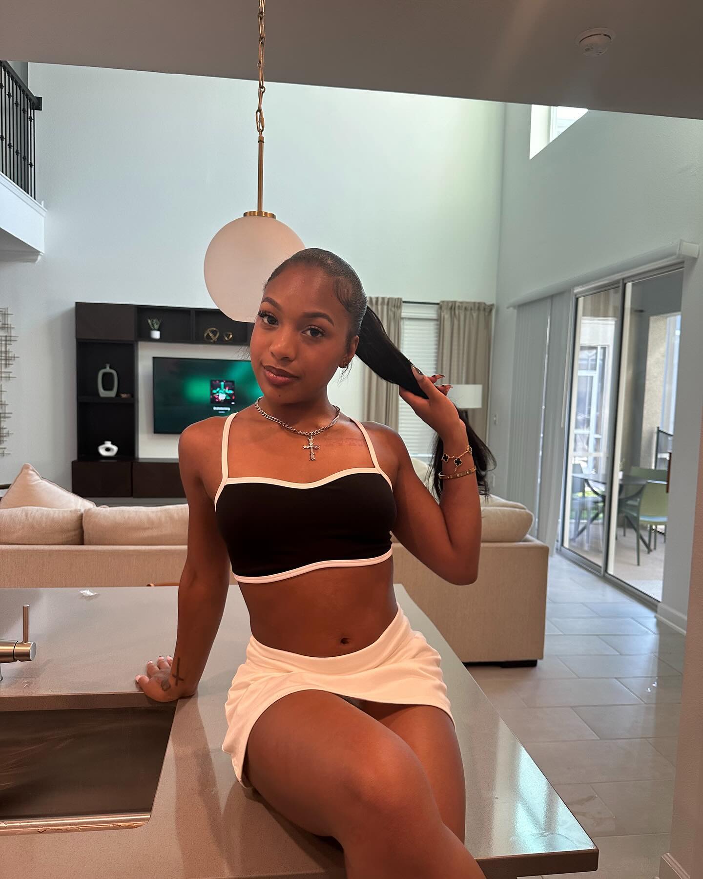 Brooklyn Frost smiling while filming a casual vlog at home, conveying a playful and confident on-camera presence