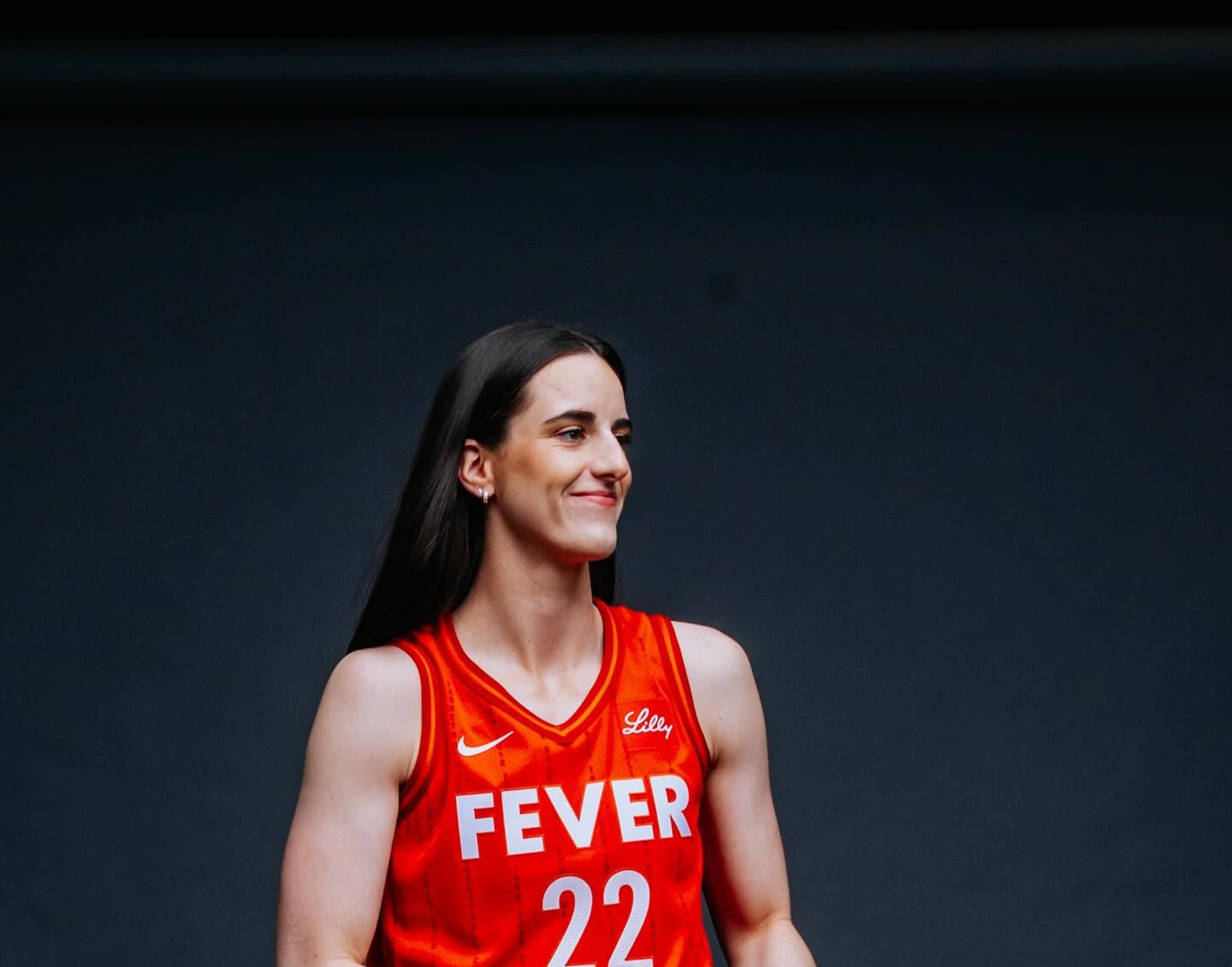 Caitlin Clark using her height and wingspan to shoot over a defender at the perimeter