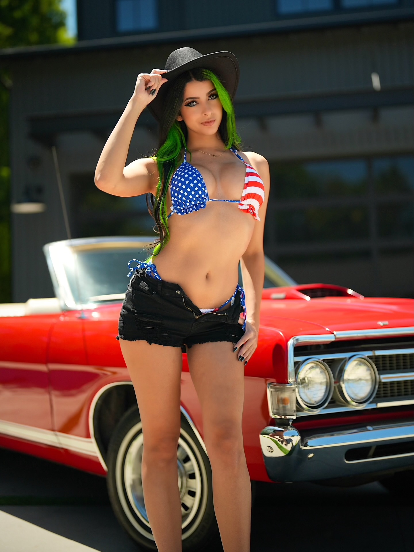 Cosplay creator in a glossy, colorful outfit striking a playful pose under studio lighting
