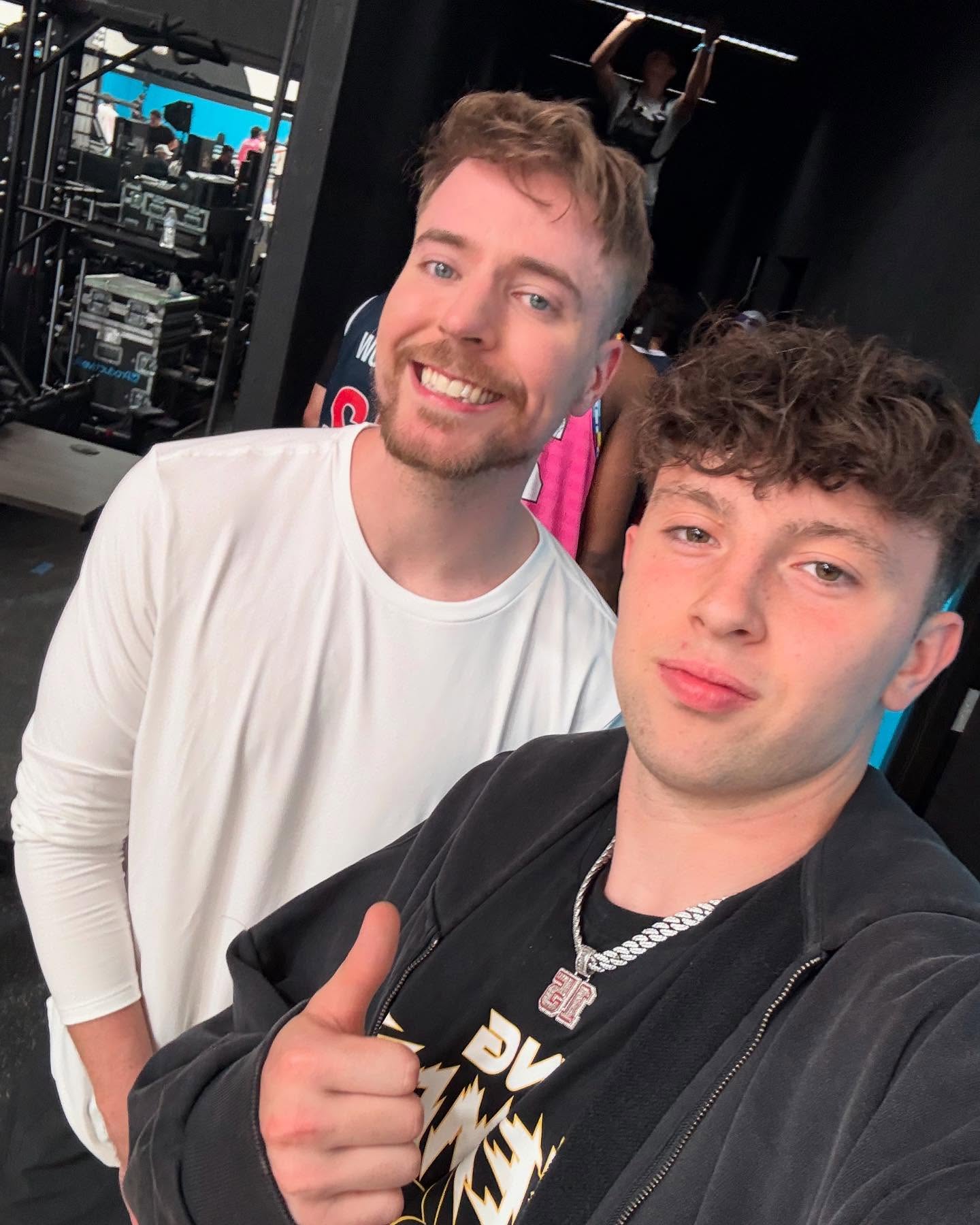 Eli Ellis dribbling a basketball on an indoor court, focused and in motion with teammates in the background