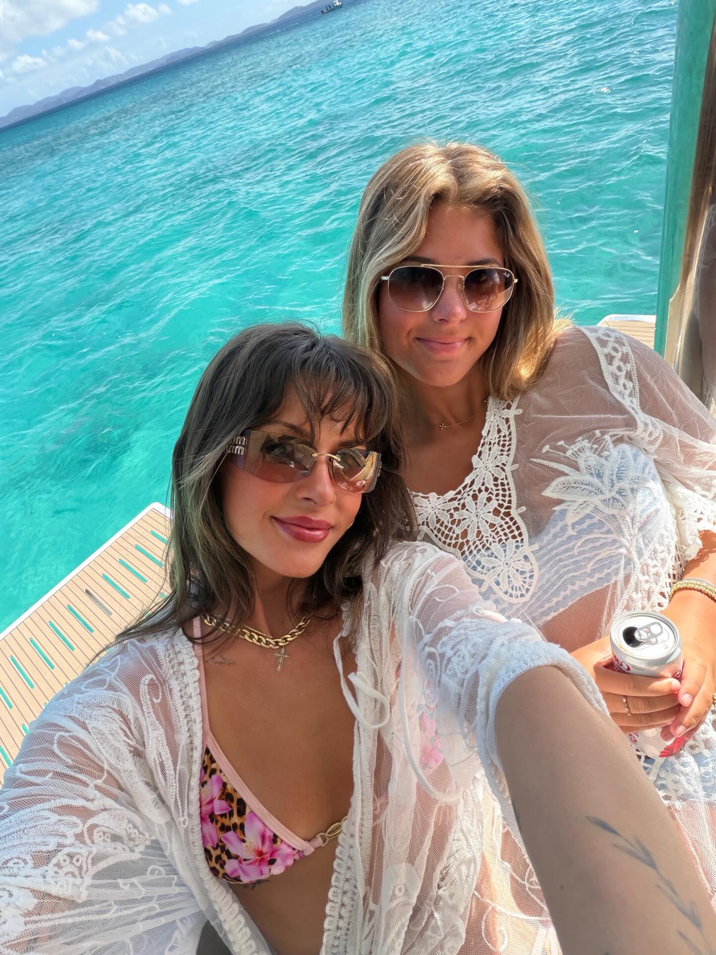 Ella Langley performing on stage with a guitar, spotlighted against a dark backdrop, conveying the emotional intensity of her country songs