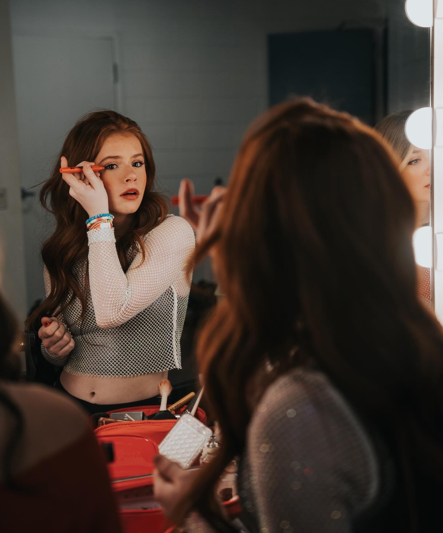 Teen creator Harper Zilmer filming a casual GRWM style video in a well lit bedroom, conveying confidence and authenticity.