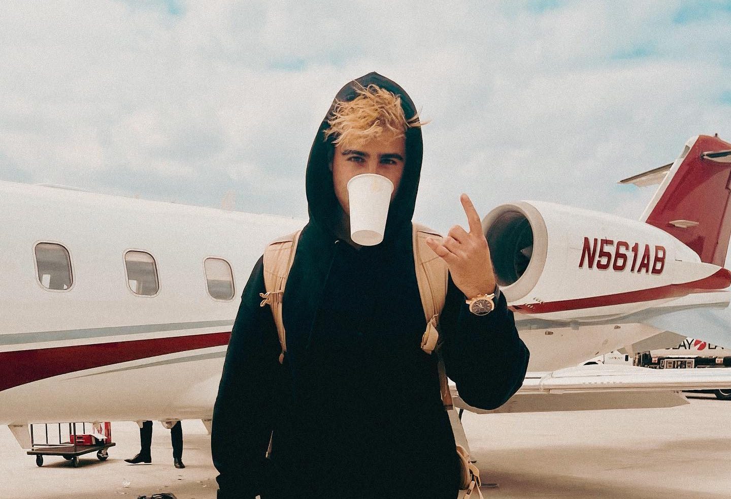 Nick Nayersina filming a vlog outdoors with a handheld camera