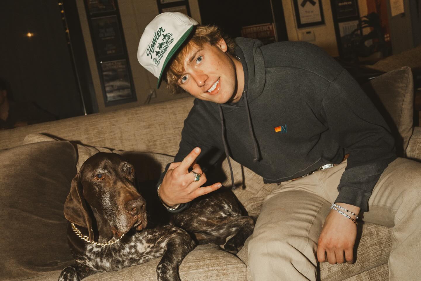 Hudson Westbrook performing on stage with a guitar under warm Texas lights, reflecting the storytelling heart of country music