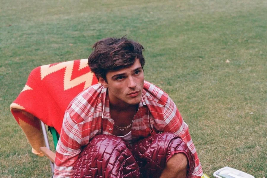 Jacob Elordi standing tall on a red carpet in a tailored suit, showcasing his height and lean build