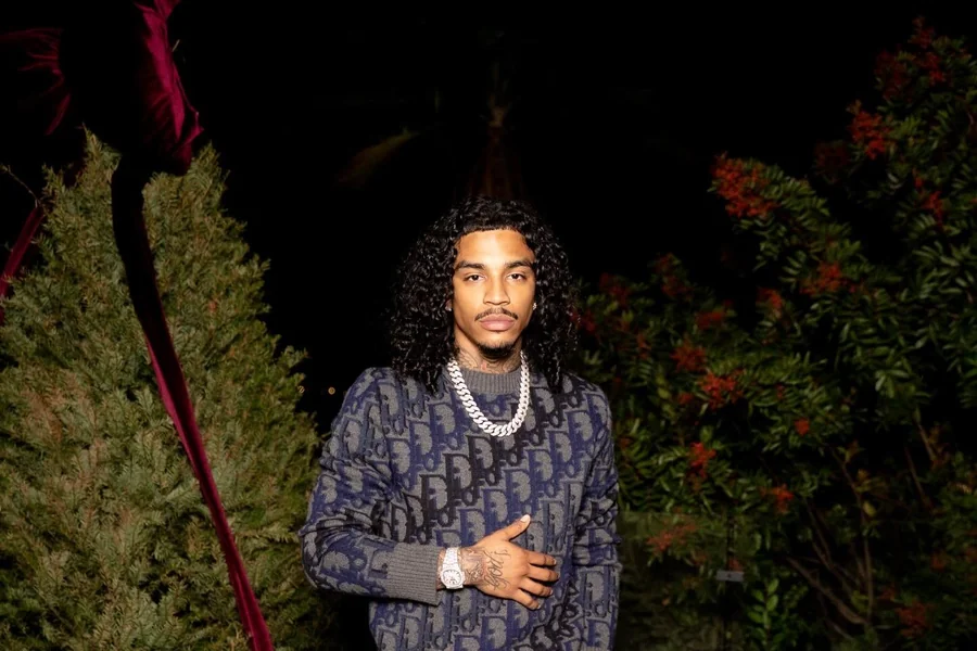 Jay Cinco in a recording studio, focused at a microphone with a contemplative expression, conveying the emotional tone of his music