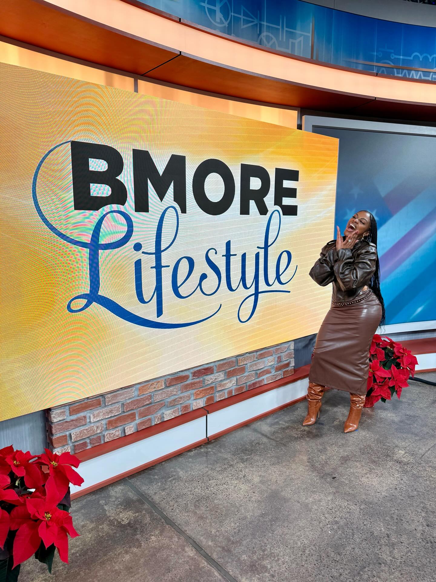 Jess Hilarious performing on stage, delivering a high energy set with expressive gestures.