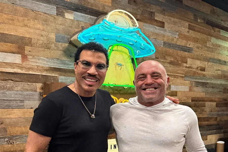 Joe Rogan standing beside much taller UFC fighters, highlighting the visual height contrast that fuels online debates