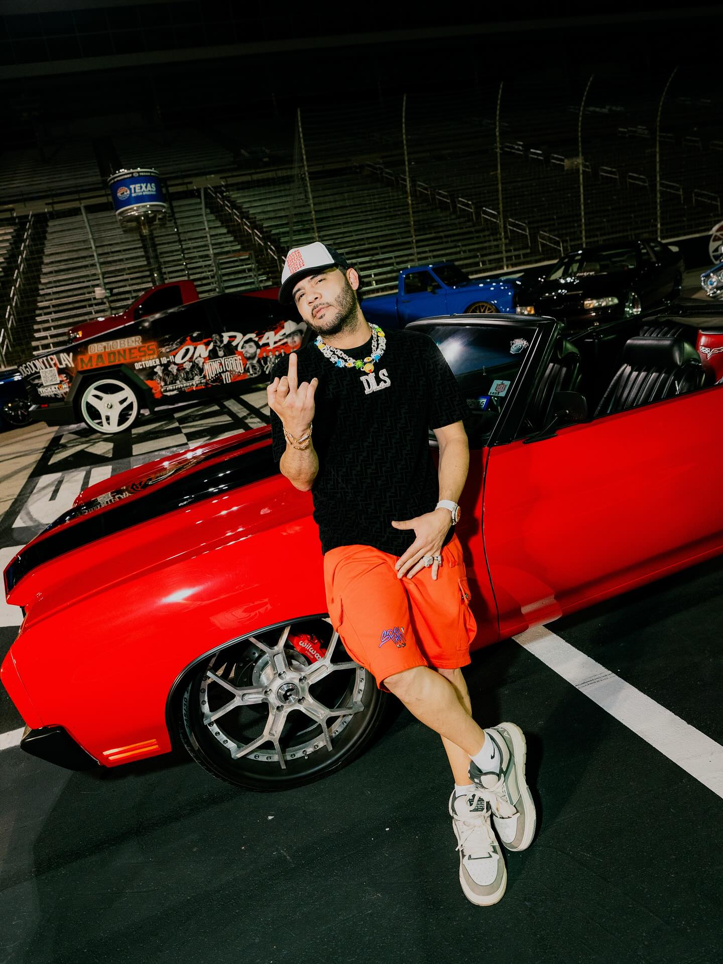 José Darey Castro performing onstage with an accordion, spotlighted against a backdrop that reflects Sonoran norteño heritage