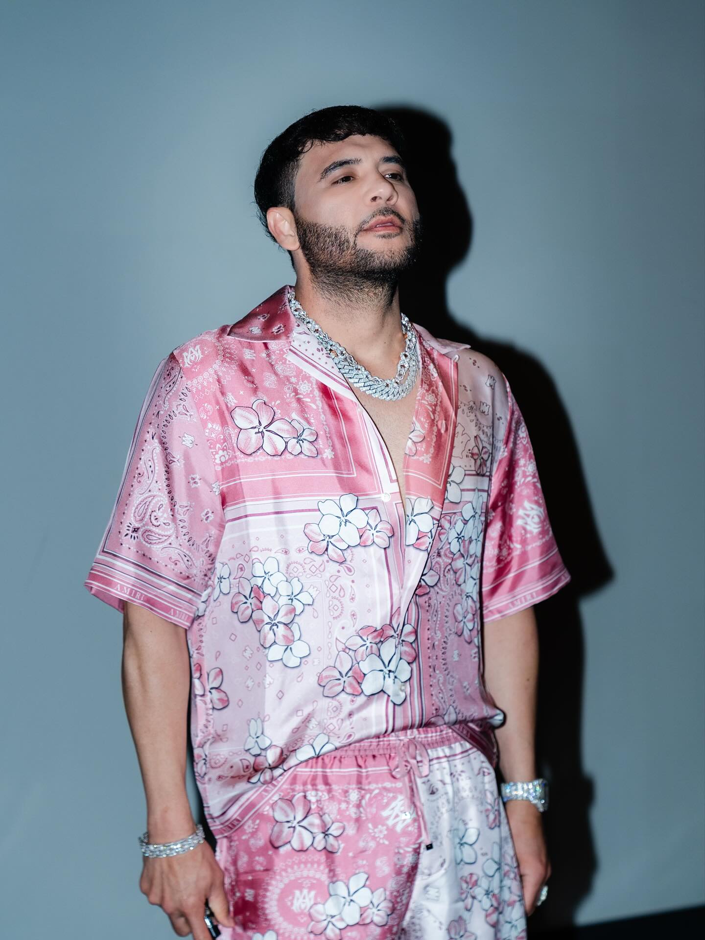 José Darey Castro performing onstage with an accordion, spotlighted against a backdrop that reflects Sonoran norteño heritage