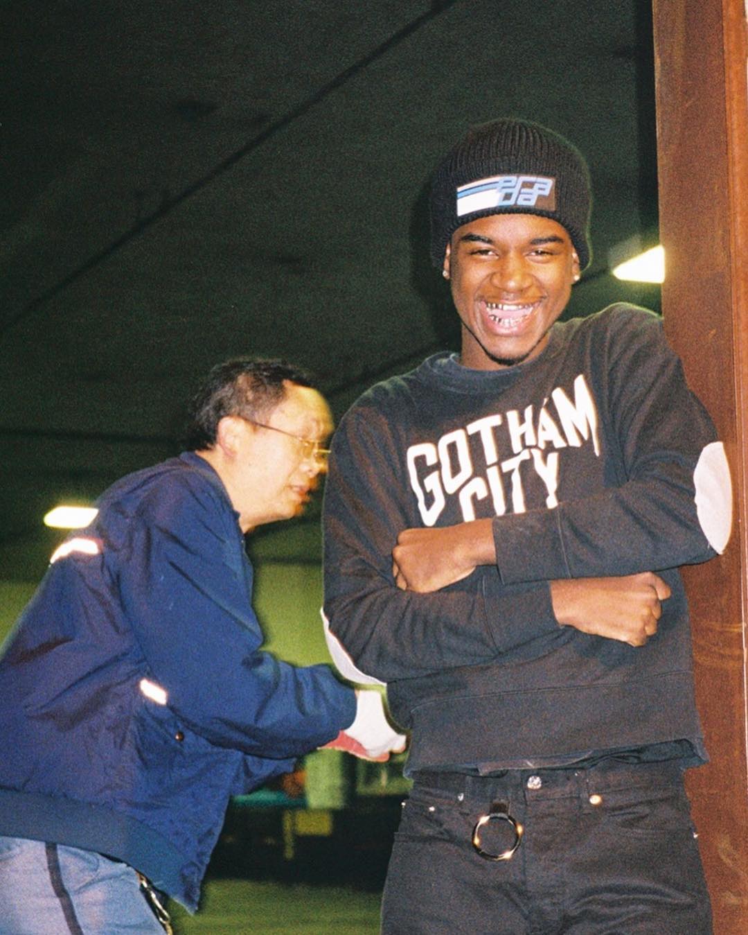 Ken Carson performing on stage under dark, futuristic lighting with an energized crowd.