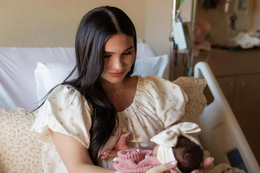 Krystiana Tiana smiling with her family in a cozy home setting, capturing the warm and relatable atmosphere that defines her content