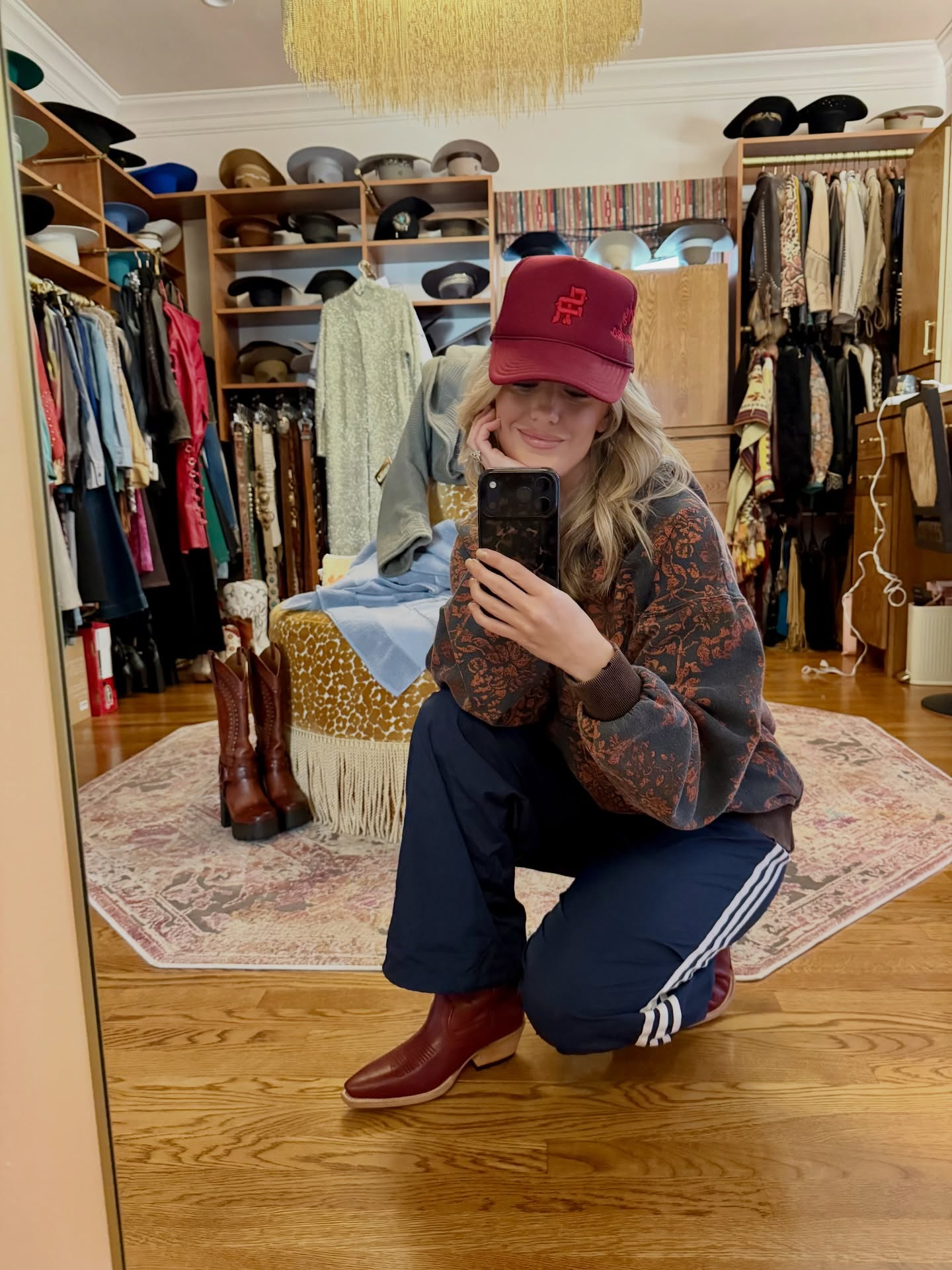Lainey Wilson performing on stage in vintage-inspired attire with a microphone in hand and warm stage lighting