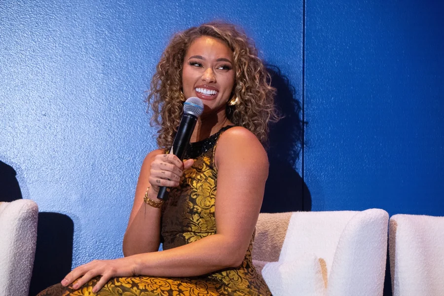 Lauren Wood in neutral athletic wear against a clean studio backdrop, reflecting fitness focus and entrepreneurial poise