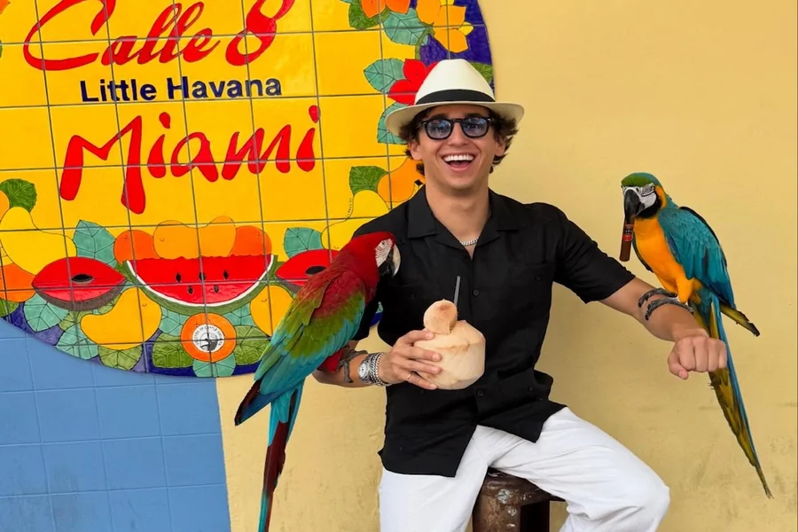 Marcello Hernandez performing a high-energy sketch on stage, highlighting his expressive movement and confident presence.