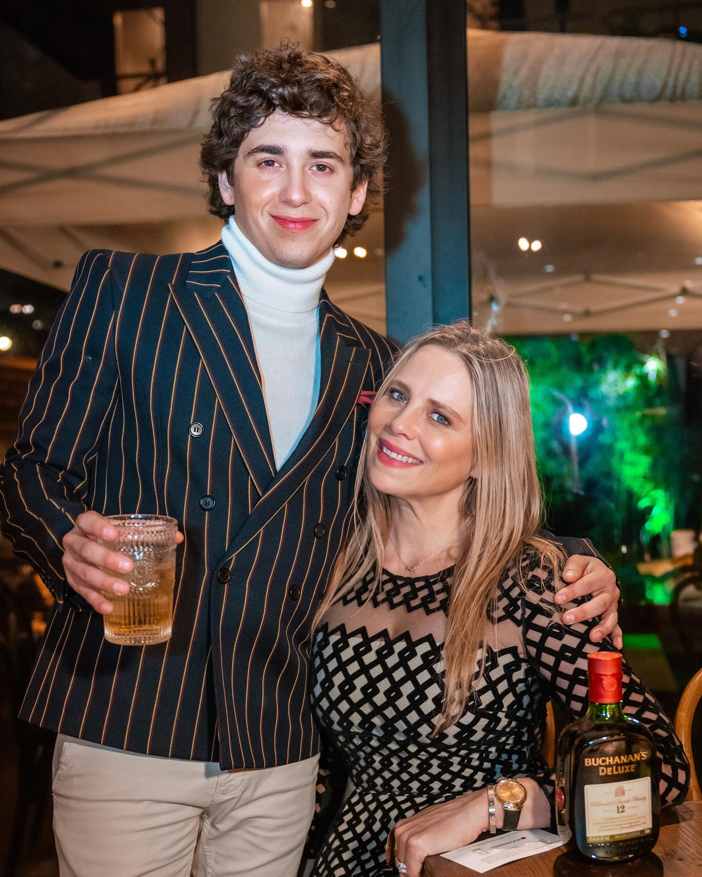 Marcello Hernandez performing a high-energy sketch on stage, highlighting his expressive movement and confident presence.