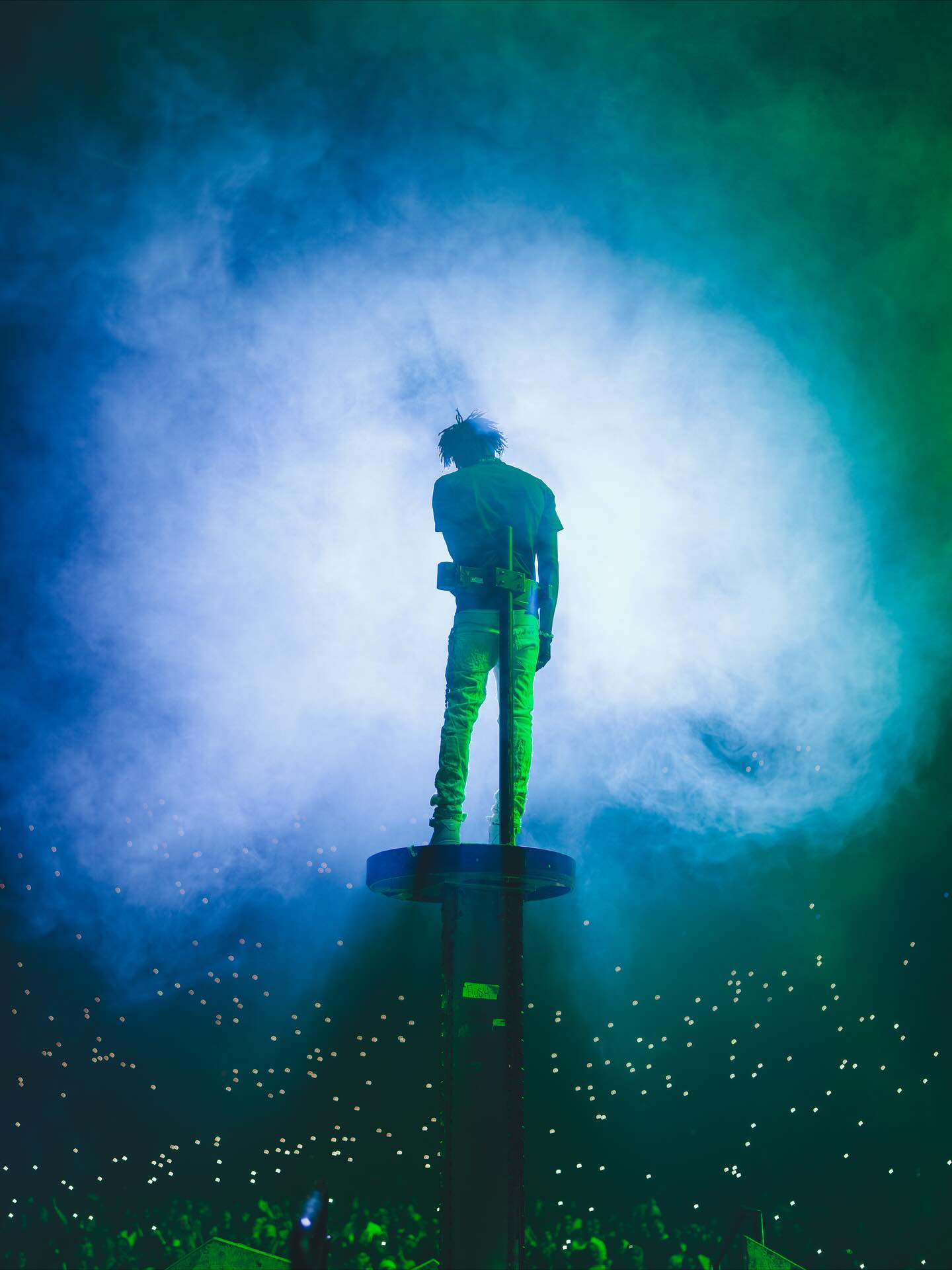 NBA YoungBoy performing on stage with expressive energy, capturing the intensity and emotion that define his music.