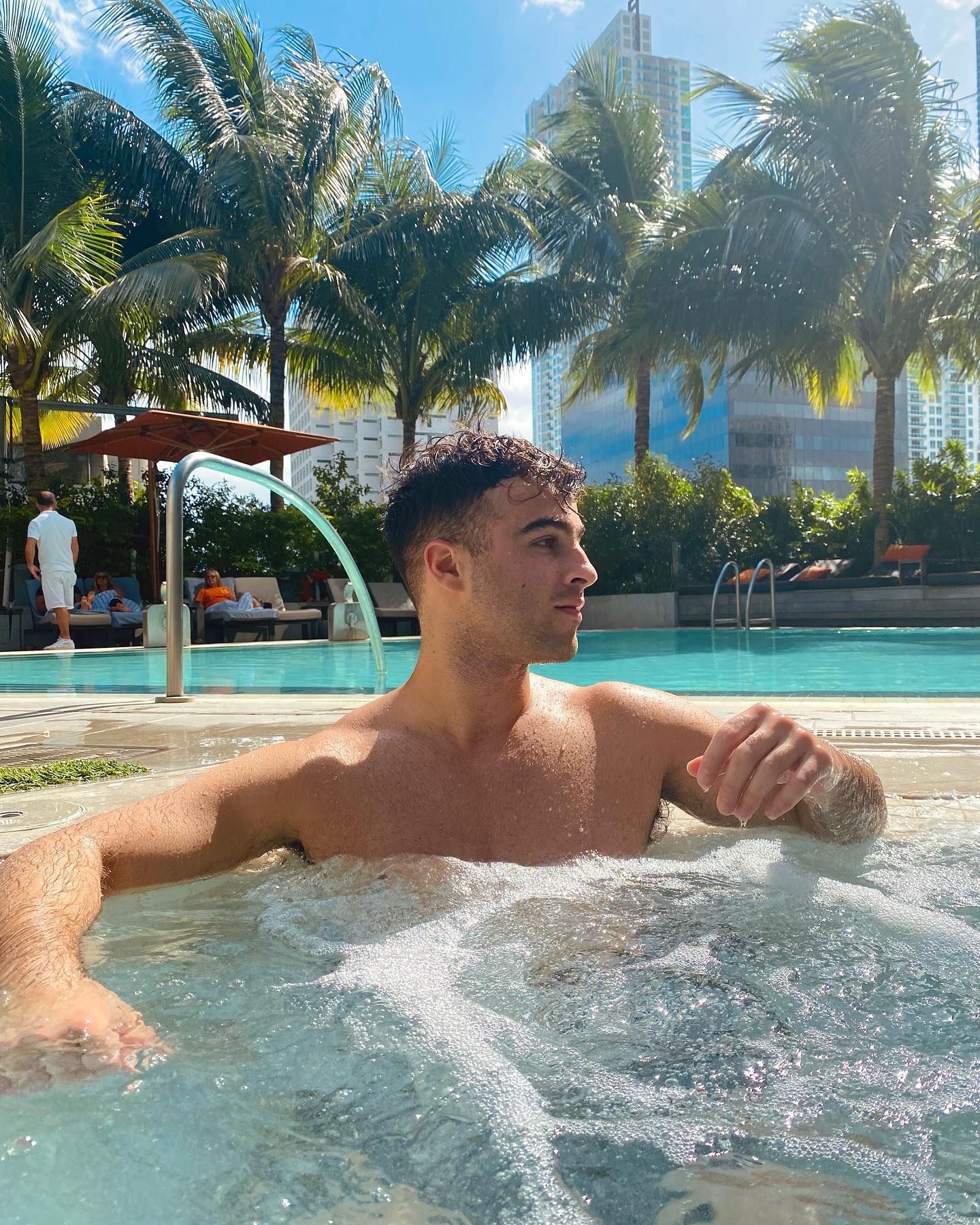 Nick Nayersina filming a vlog outdoors with a handheld camera