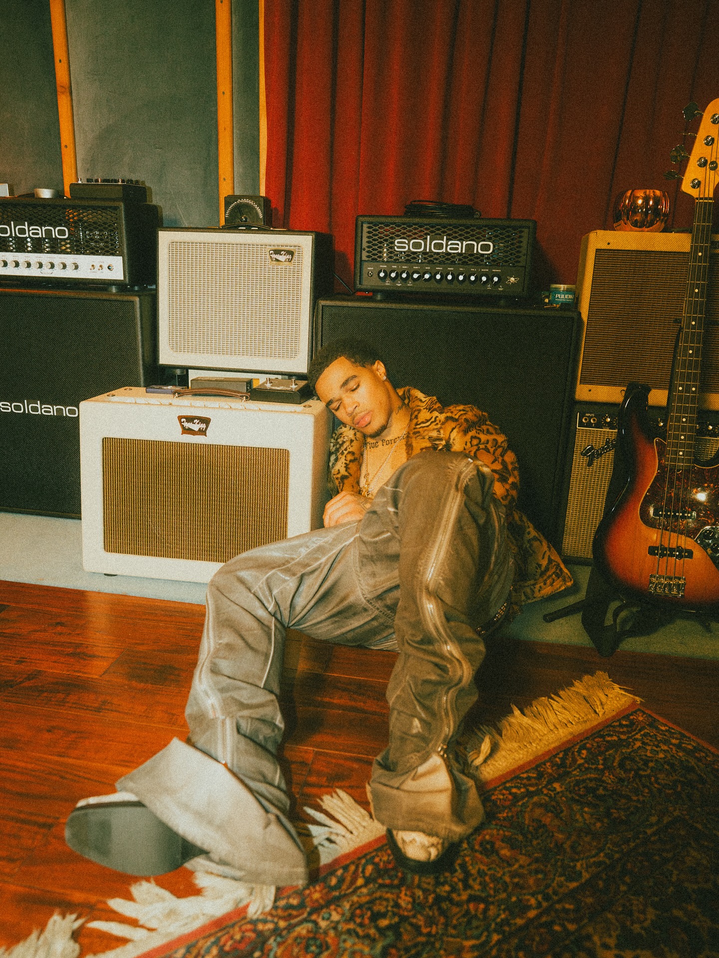 Plaqueboymax streaming at a desk with music production gear, microphone, and chat window visible on screen