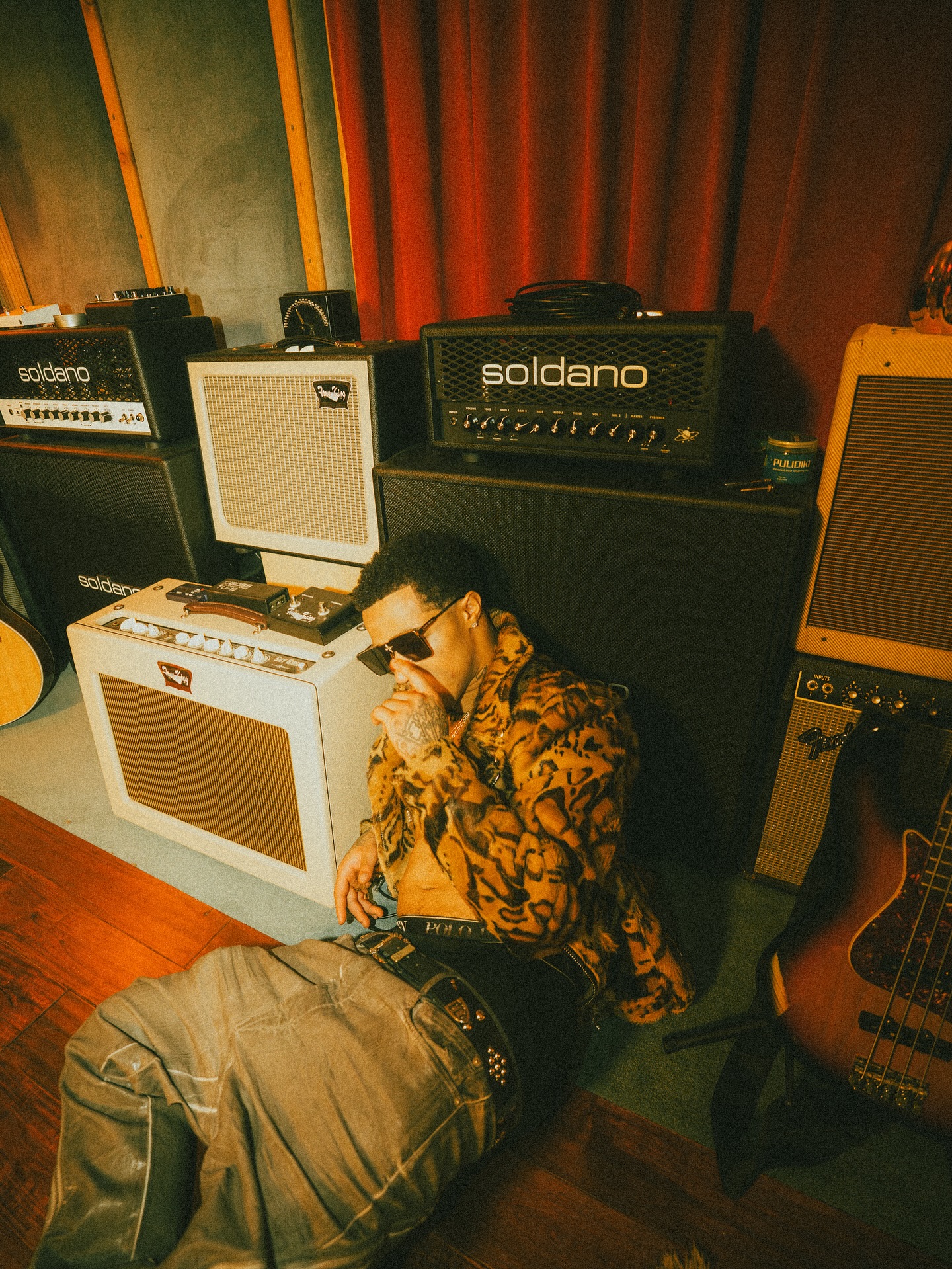 Plaqueboymax streaming at a desk with music production gear, microphone, and chat window visible on screen