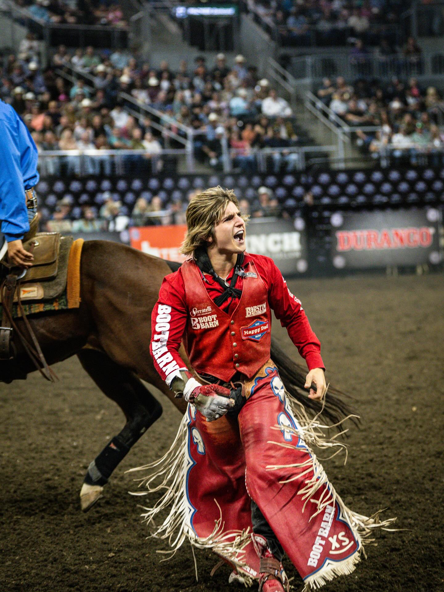 Rocker Steiner rides a bareback bronc, legs driving in rhythm as the horse kicks in midair, capturing the power and balance of modern rodeo.