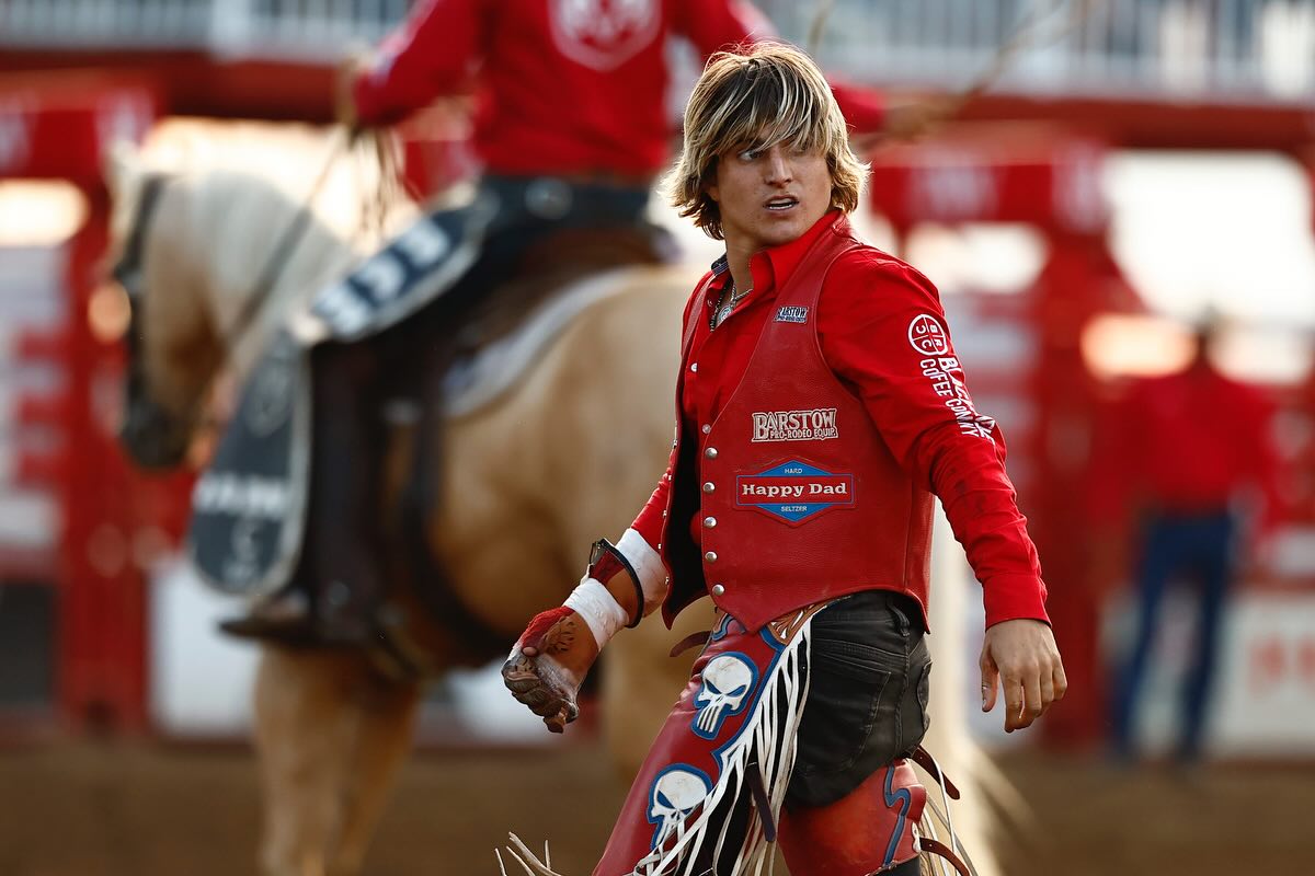 Rocker Steiner rides a bareback bronc, legs driving in rhythm as the horse kicks in midair, capturing the power and balance of modern rodeo.