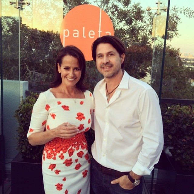 Rodger Berman at a fashion media event, dressed in a tailored suit, speaking with confidence in a professional setting