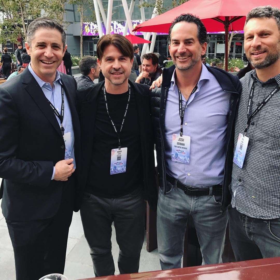 Rodger Berman at a fashion media event, dressed in a tailored suit, speaking with confidence in a professional setting