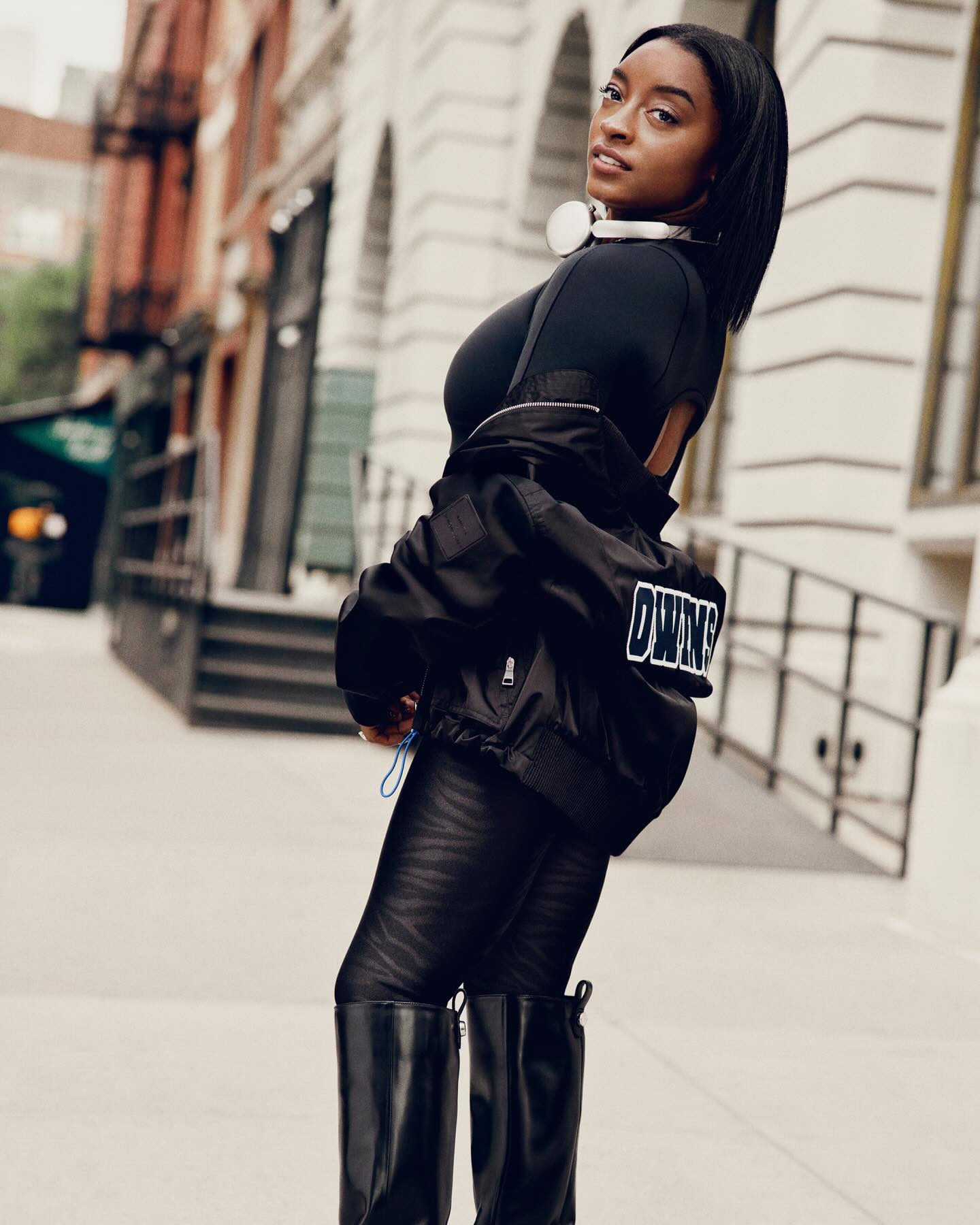 Simone Biles performing a high tumbling pass that highlights her lift and tight rotation.