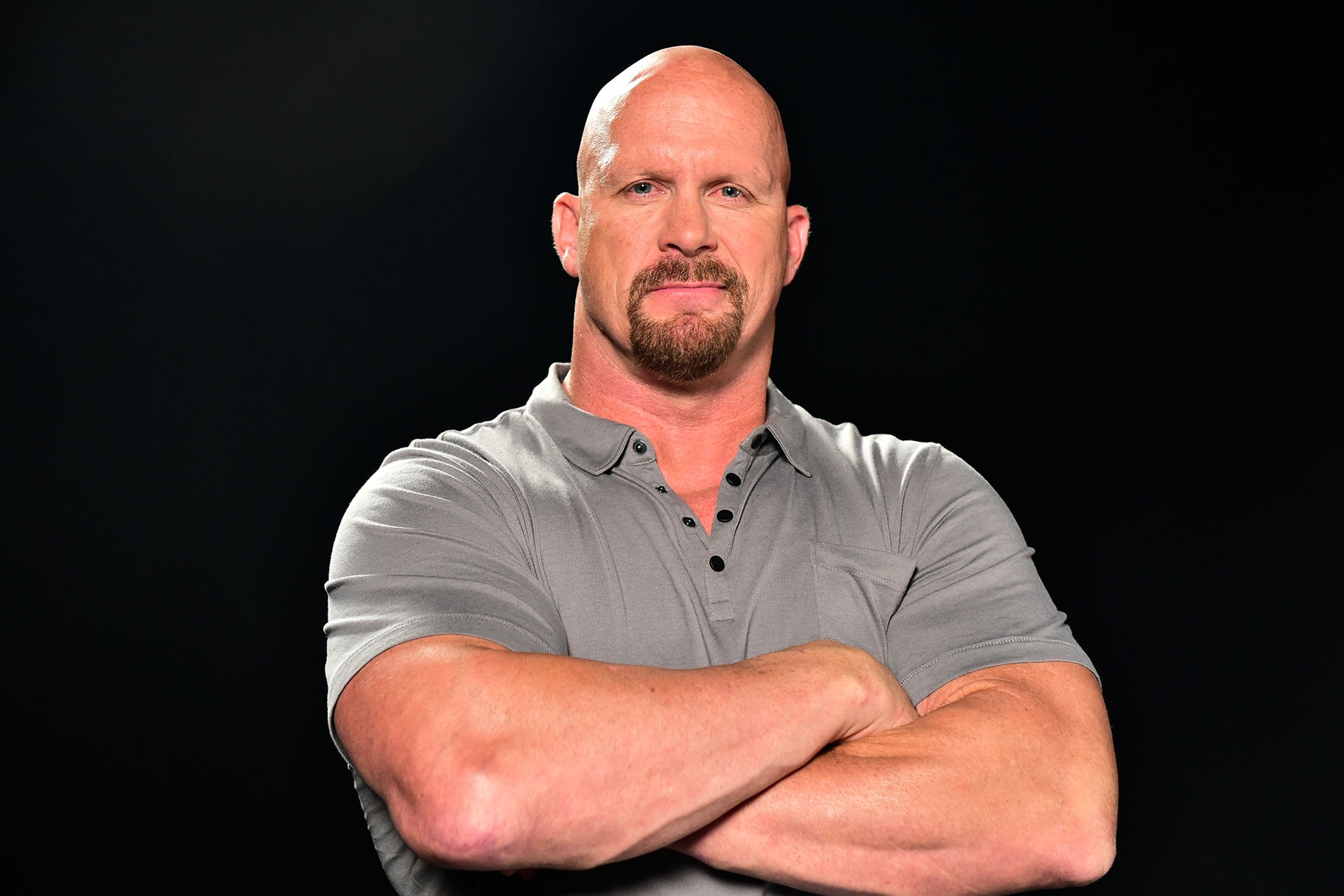 Stone Cold Steve Austin in a booking photograph that contrasts his ring persona with a stark, standardized setting