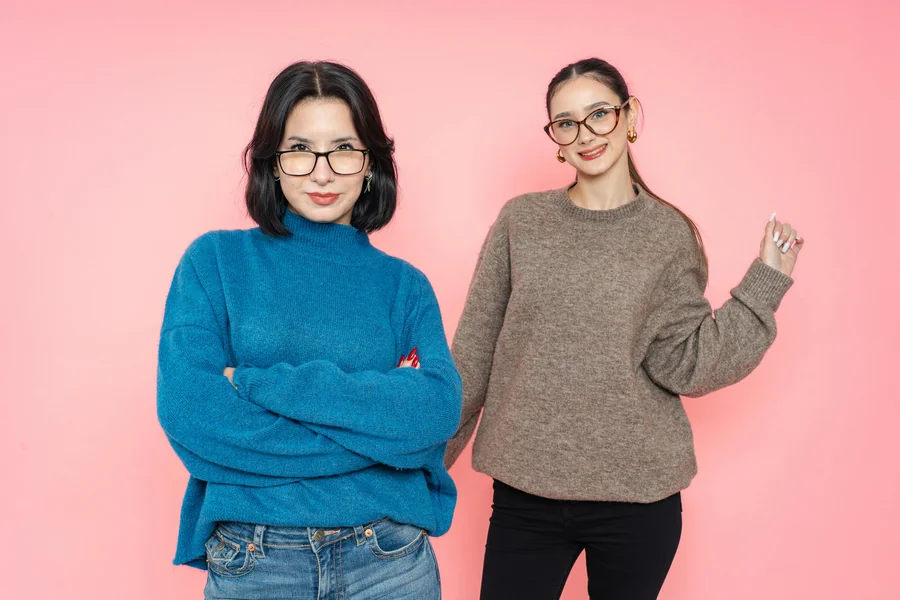 Person wearing an oversized sweater styled with slim bottoms and boots, showing balanced proportions for a street ready look