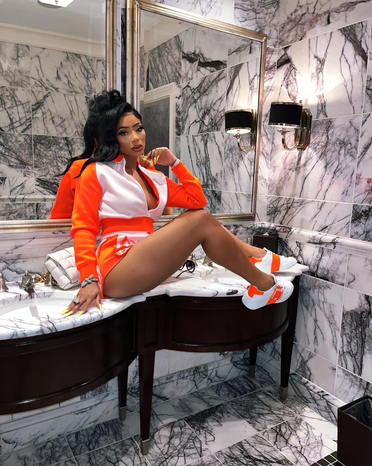 Tommie Lee posing in a glamorous outfit, highlighting her bold fashion sense and confident public persona