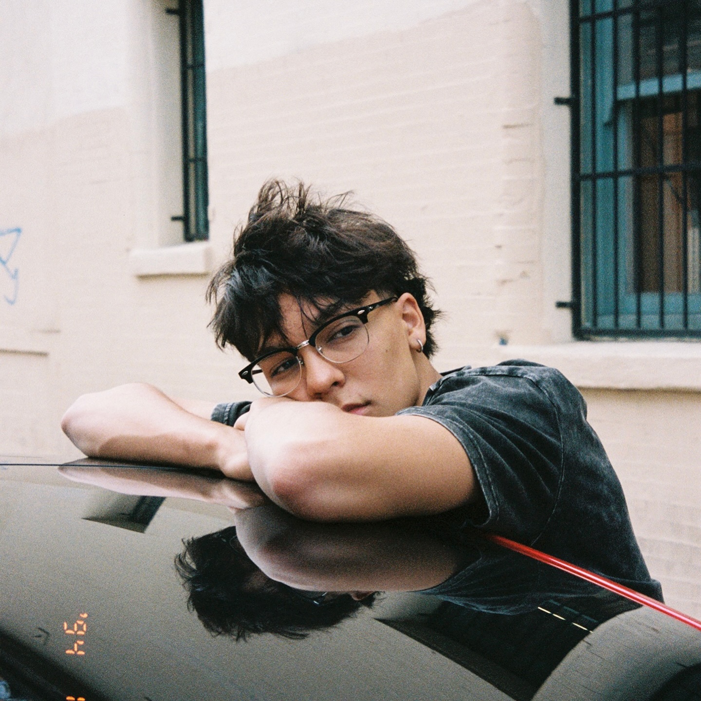 Trey Makai performing a contemporary dance move with focused expression and clean lines against an urban backdrop