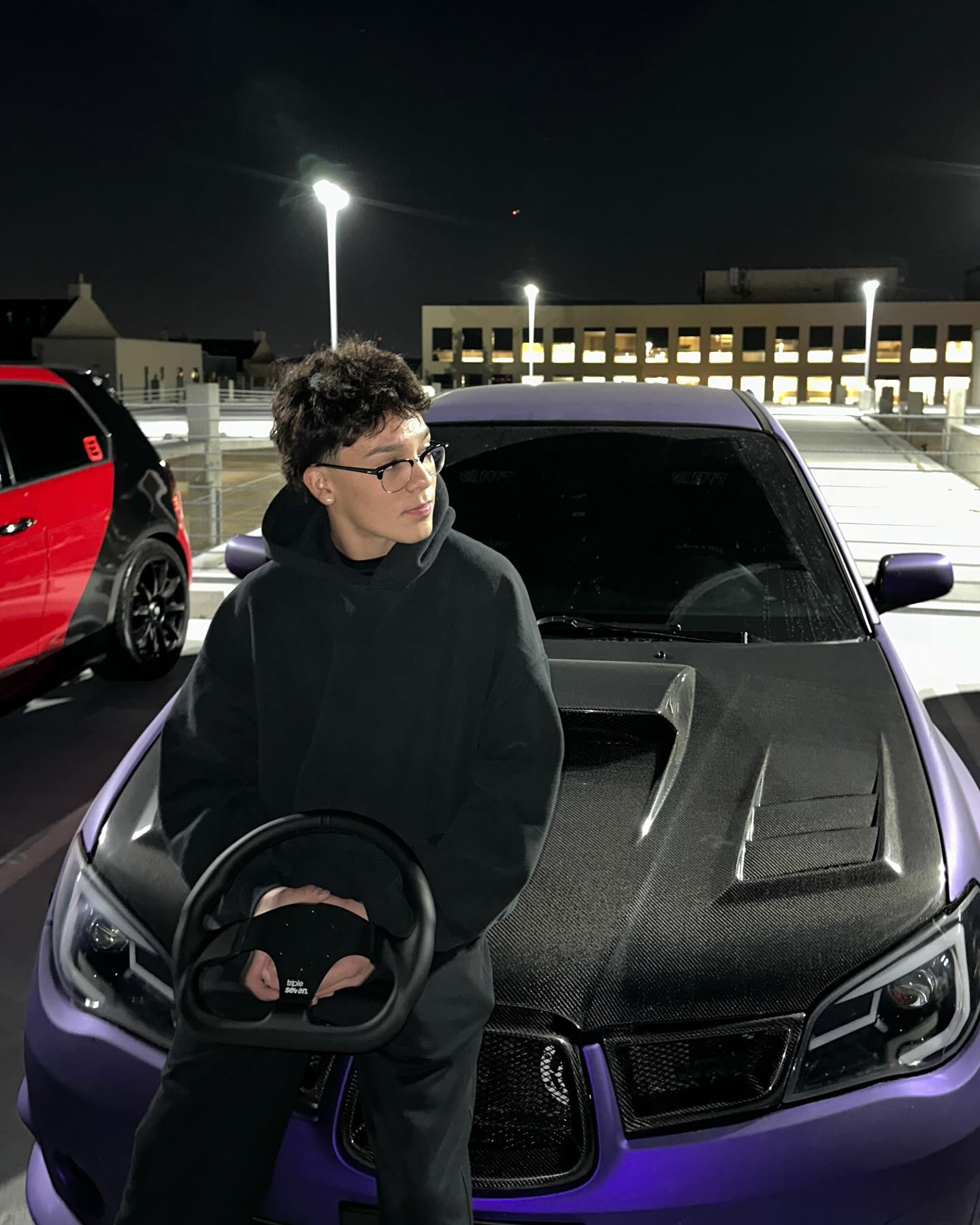 Trey Makai performing a contemporary dance move with focused expression and clean lines against an urban backdrop