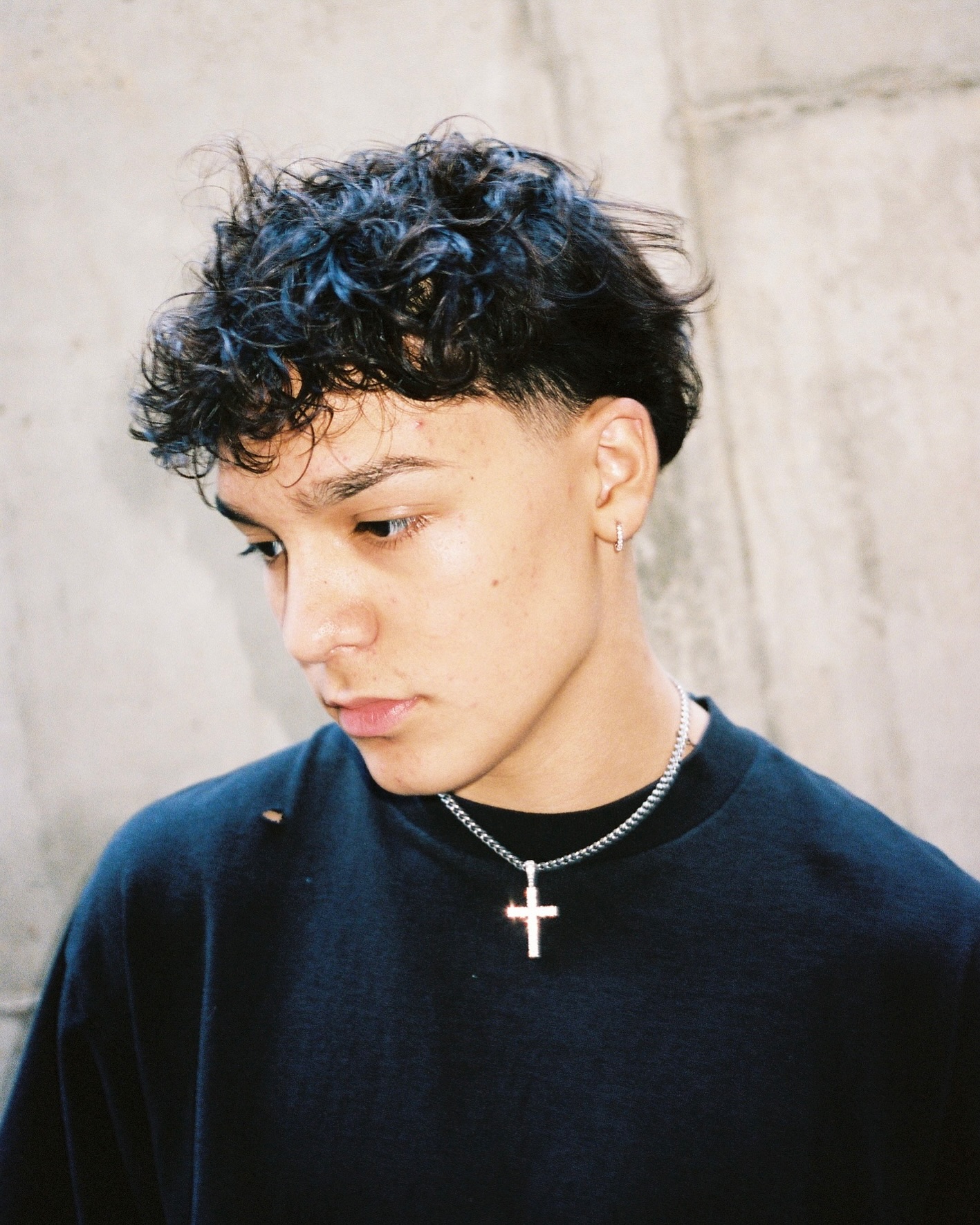 Trey Makai performing a contemporary dance move with focused expression and clean lines against an urban backdrop