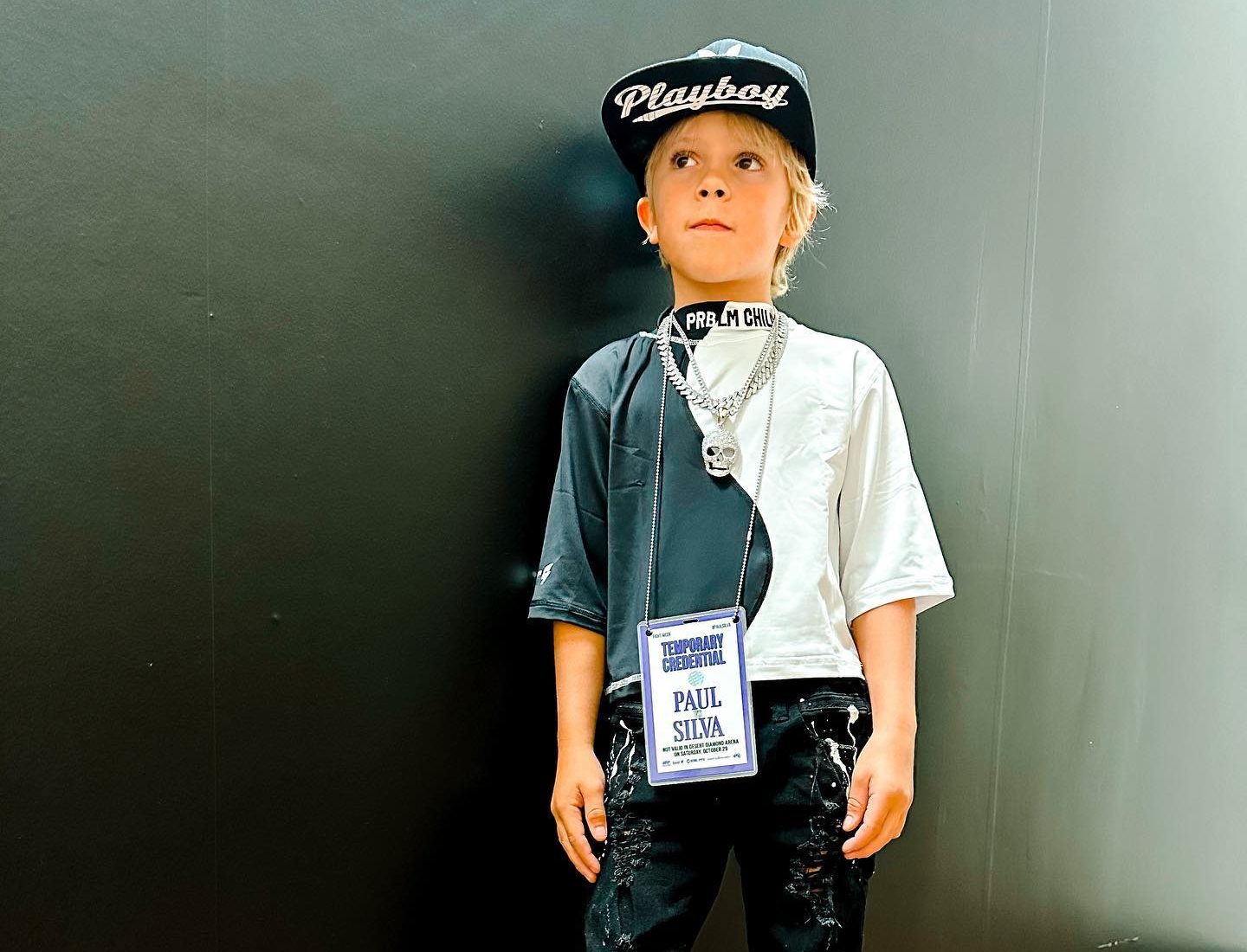 Young creator Tydus Talbott smiling with his family, representing a childhood spent in front of the camera and shaped by supportive parenting.