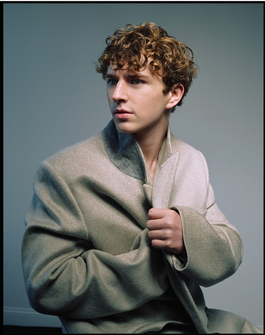 Walker Scobell at a press event, smiling and speaking with confidence.