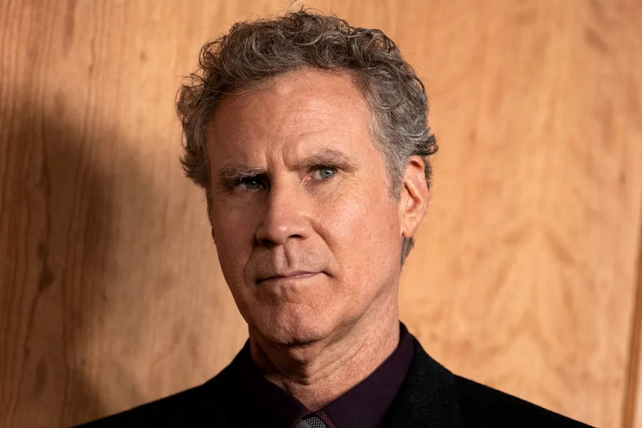 Will Ferrell smiling in a formal setting, captured with a relaxed posture and friendly expression