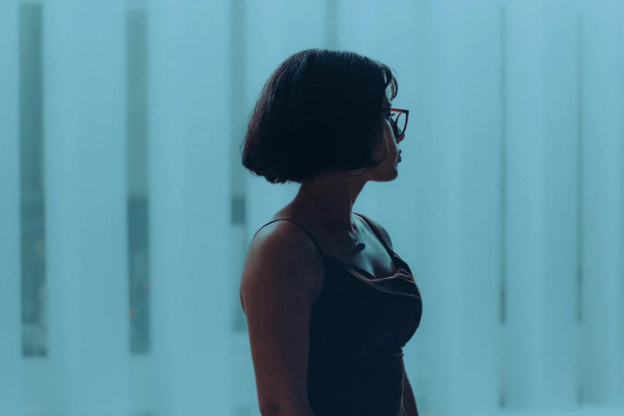 Woman with a short layered bob showing soft surface layers and a tapered nape, styled with light volume and natural movement