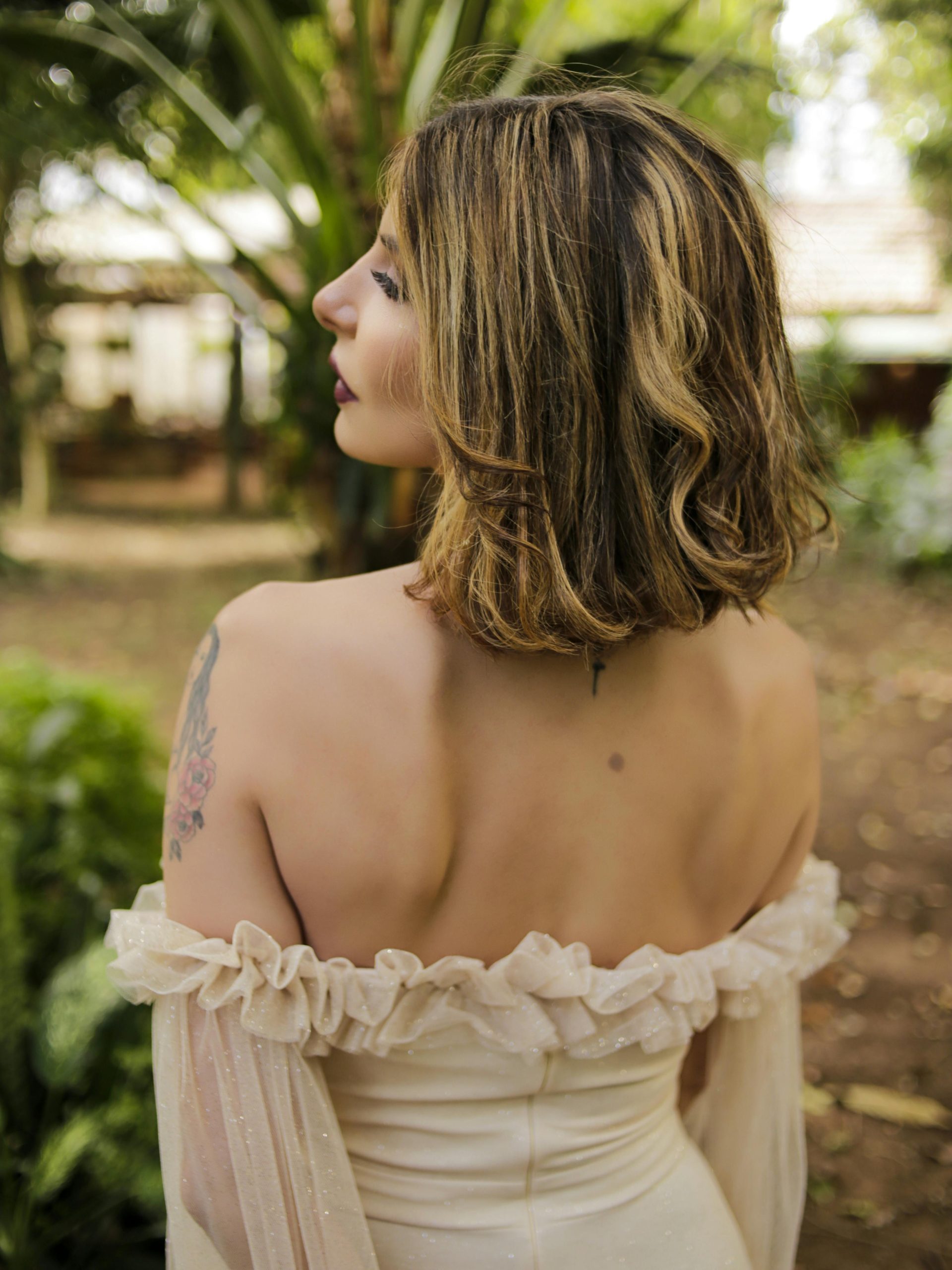 Woman with shoulder-length hair styled in soft, natural waves that move around the collarbone.