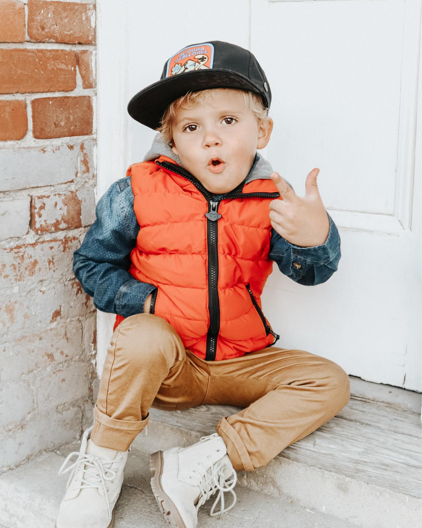 Young creator Tydus Talbott smiling with his family, representing a childhood spent in front of the camera and shaped by supportive parenting.
