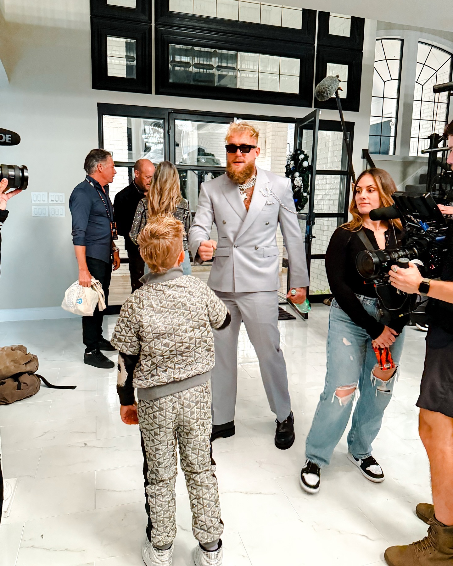Young creator Tydus Talbott smiling with his family, representing a childhood spent in front of the camera and shaped by supportive parenting.