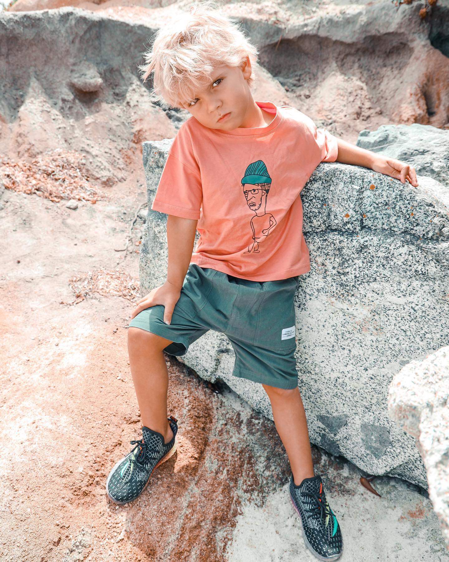Young creator Tydus Talbott smiling with his family, representing a childhood spent in front of the camera and shaped by supportive parenting.