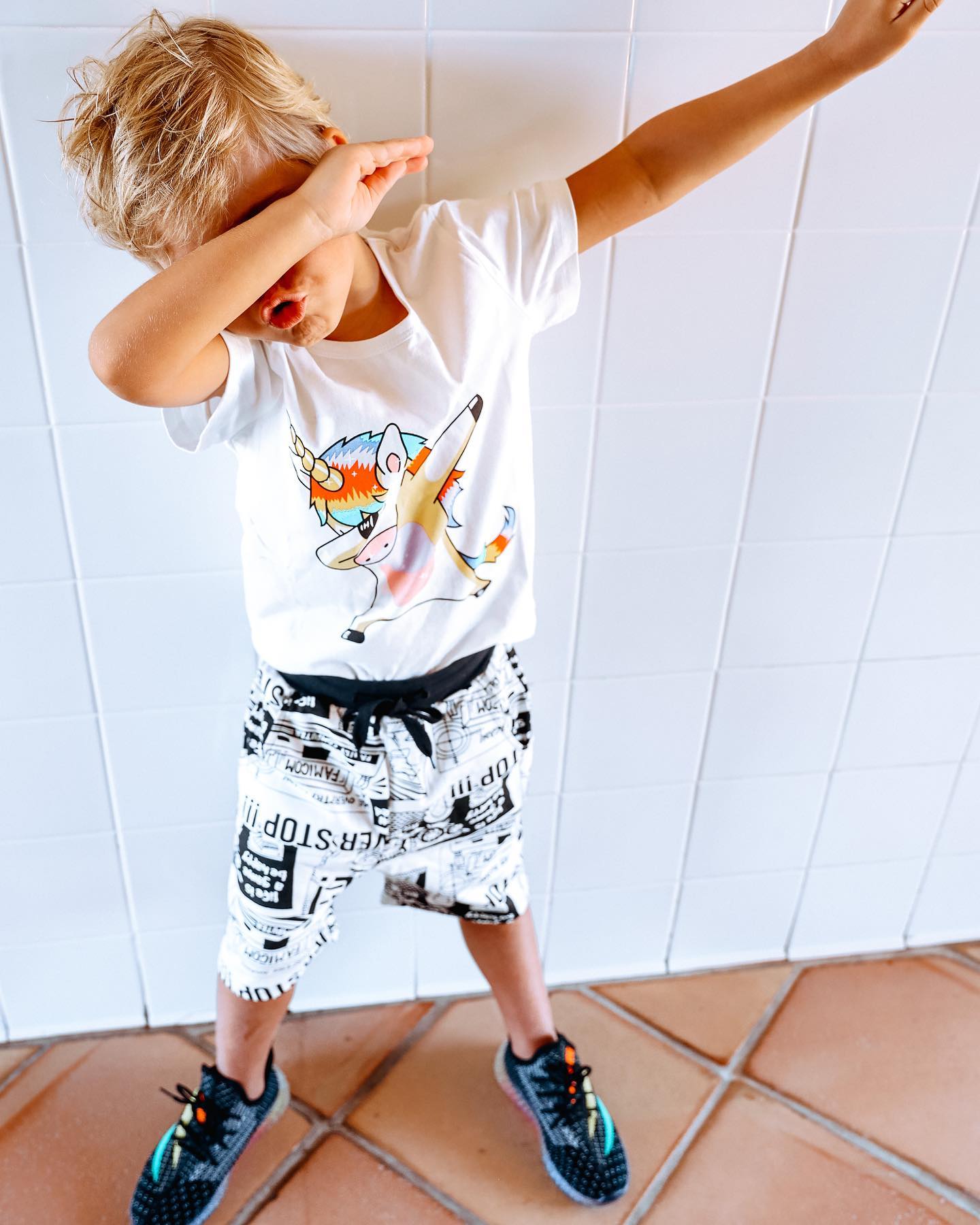 Young creator Tydus Talbott smiling with his family, representing a childhood spent in front of the camera and shaped by supportive parenting.