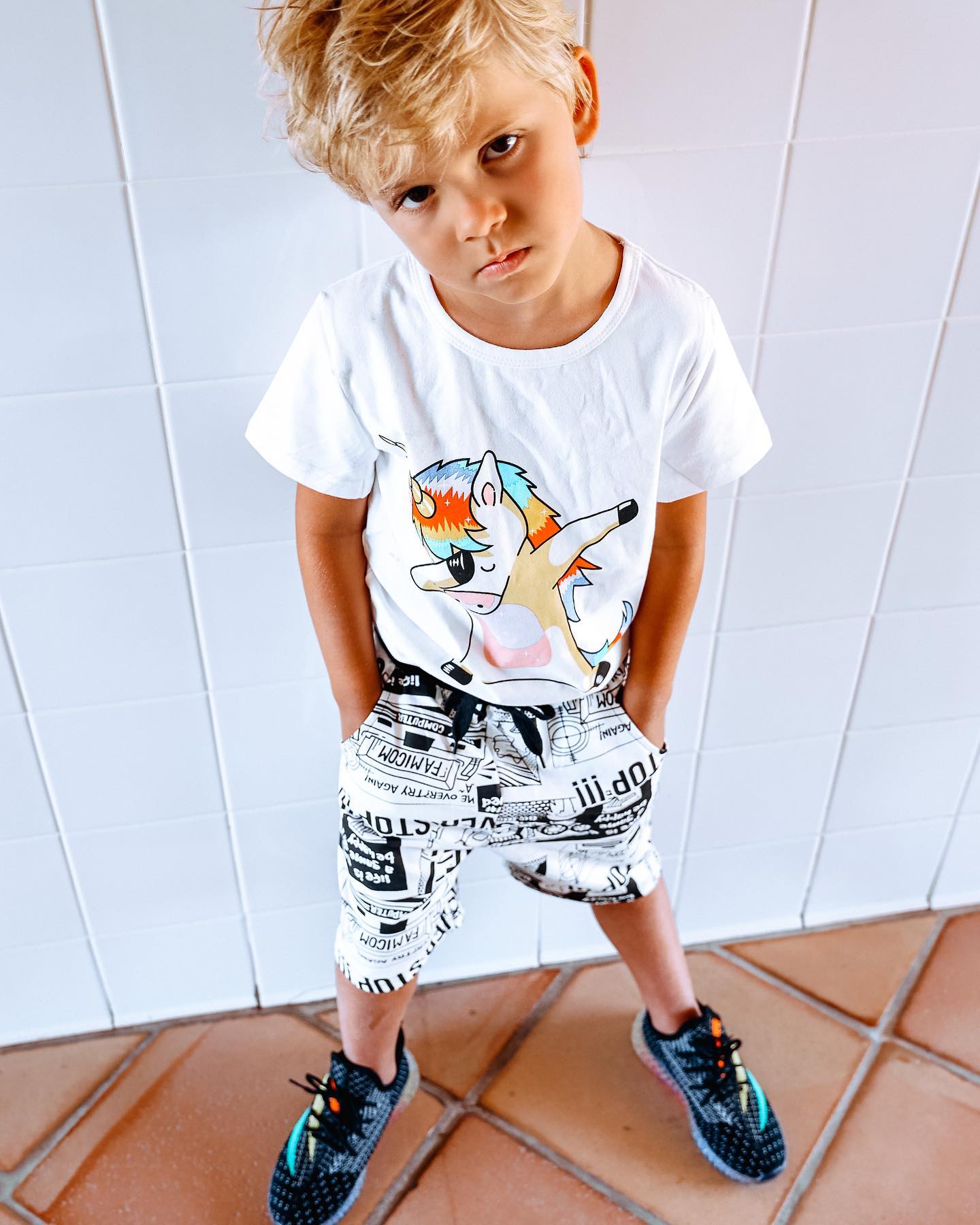 Young creator Tydus Talbott smiling with his family, representing a childhood spent in front of the camera and shaped by supportive parenting.